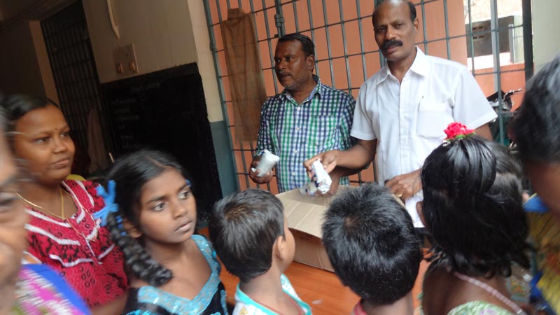 ALL INDIA NEWSPAPER EDITORS AND PUBLISHERS ASSOCIATION Helped People During Flood by providing biscuits DR.S.RAJENDRAN AINP President
